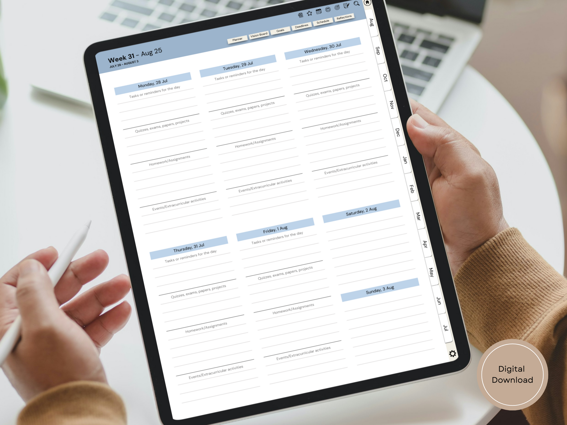 An angled shot of the college-friendly dated digital planner resting on a desk with coffee and study notes around it.